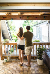 Rear view of couple standing on balcony - JOSF02647