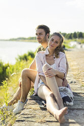Couple relaxing at the riverside in summer - JOSF02663