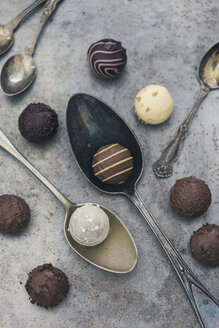 Various chocolate truffles and old spoons - JUNF01163