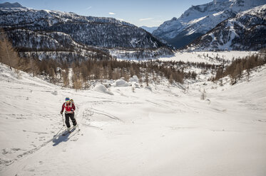 Girl cross country skiing above Devero Valley. Baceno, Ossola, Italy. - AURF03193