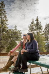 Girls laughing on the Deck with snow in background - AURF03196