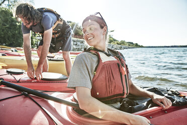 Young woman looking back at tandem kayak partner, Portland, Maine, USA - AURF03302