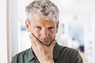 Portrait of mature man with grey hair and stubble at home - TCF05825