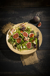 Mixed salad with figs, tomatoes, sheep cheese, grissini with ham on bambus plate - MAEF12732