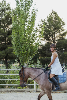 Happy woman riding on horse - KKAF01574