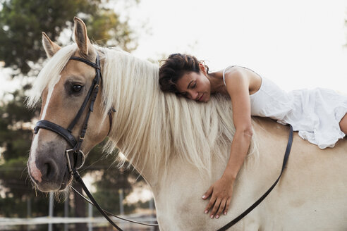 Woman relaxing on horseback - KKAF01608