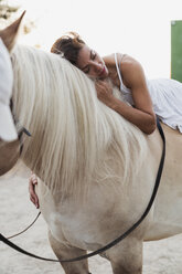 Woman relaxing on horseback - KKAF01609