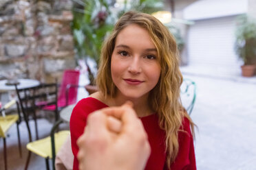 Portrait of young woman holding hands at pavement cafe - MGIF00242