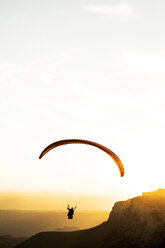 Paraglider flying, mountains in the background during sunset - ACPF00314