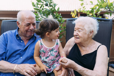 Grandparents and granddaughter spending time together on the terrace - GEMF02381