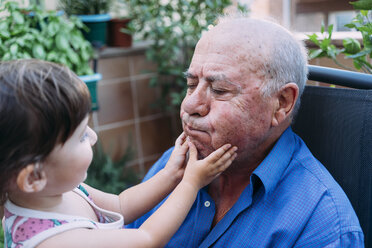 Grandfather and baby girl playing together on the terrace - GEMF02389