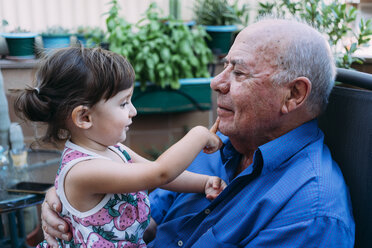 Grandfather and baby girl playing together on the terrace - GEMF02390