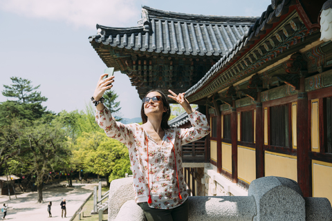 South Korea, Gyeongju, happy woman taking a selfie with cell phone in Bulguksa Temple stock photo