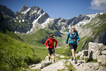 Man and woman hiking, Appenzellerland, Switzerland. - AURF03383