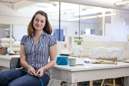 Porträt einer strickenden Künstlerin im Atelier für Faserkunst - AURF03470