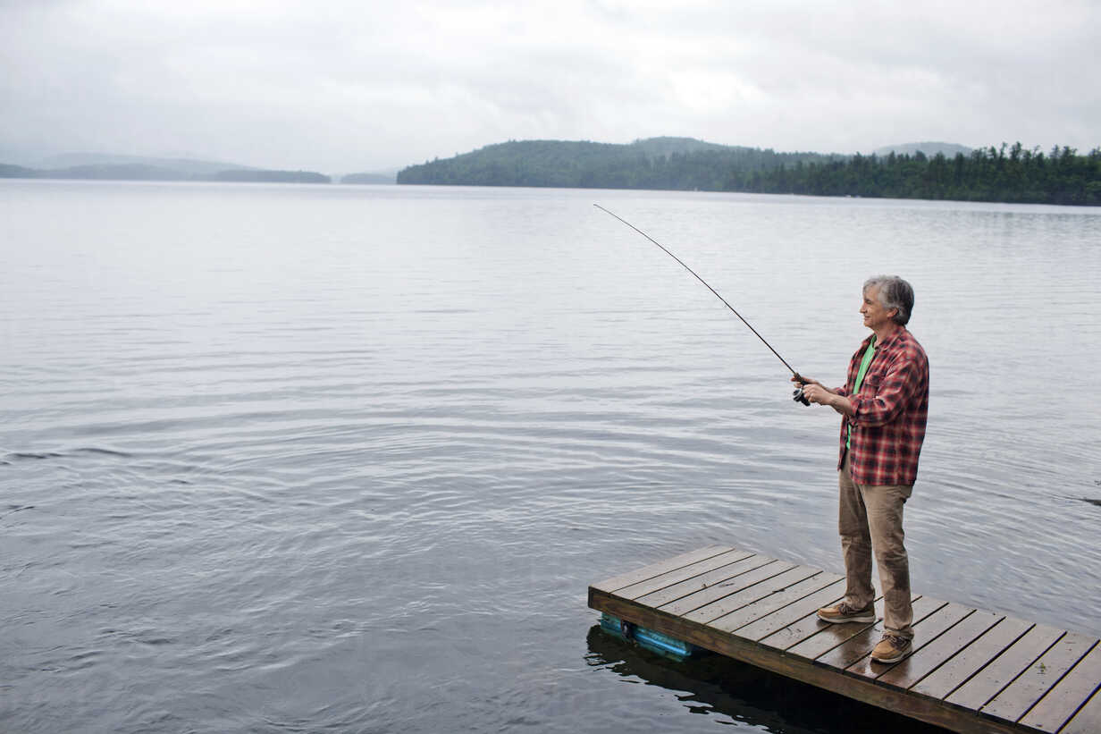 Senior man fishing off dock at Kezar Lake stock photo