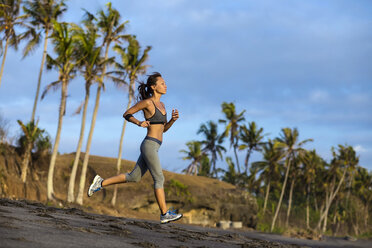 Running on the beach in Bali, Indonesia - AURF03544