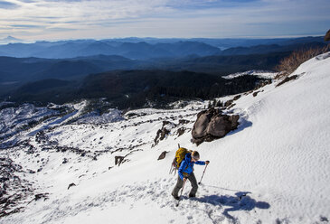 A climber moves uphill through the snow while attempting to summit Mt. St. Helens in Washington. - AURF03580