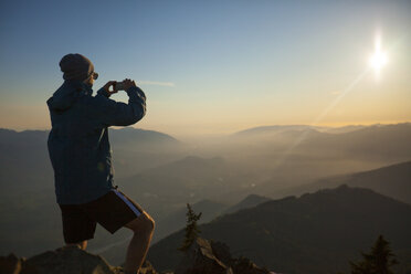 Ein Wanderer macht mit seinem Smartphone ein Foto von der Aussicht auf dem Gipfel des Sauk Mountain. - AURF03688