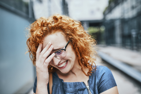 Portrait of a young redheaded woman wearing glasses, smiling stock photo