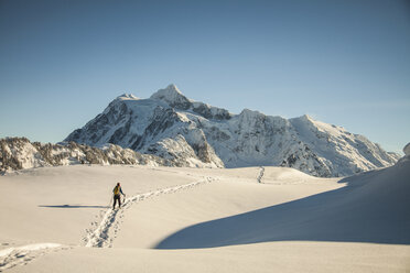 A snowshoer walks toward Mount Shuksan. - AURF03739