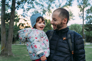 Father and little daughter having fun together in autumnal park - GEMF02410