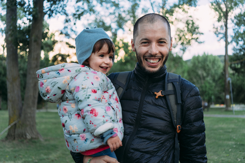 Portrait of father and little daughter having fun together in autumnal park stock photo
