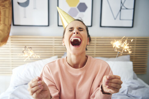 Cheerful woman during her birthday with sparklers - ABIF00978