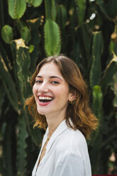 Portrait of a young woman in front of cacti - KKAF01658