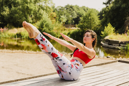 Young woman practicing Pilates in an urban park - NMSF00226