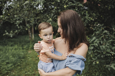 Mother holding baby in garden - KMKF00545