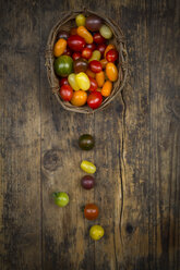 Basket of Heirloom tomatoes on wood - LVF07419
