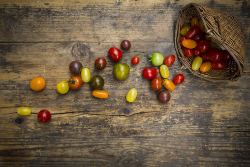 Heirloom-Tomaten und Weidenkorb auf Holz - LVF07421