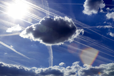 Blue sky with clouds, sun and vapour trails - NDF00795