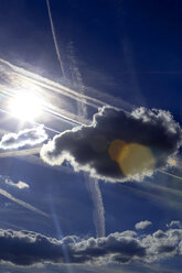 Blue sky with clouds, sun and vapour trails - NDF00796
