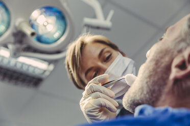 Dental surgeon during surgical procedure on a patient - MFF04571