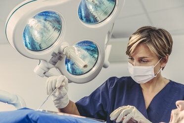 Dental surgeon during surgical procedure on a patient - MFF04573