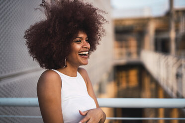 Portrait of laughing young woman at evening twilight - KKAF01756