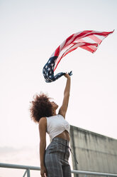 Young woman swinging American flag - KKAF01768