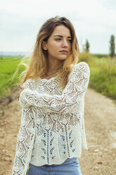 Portrait of a young woman on a dirt road - ACPF00335