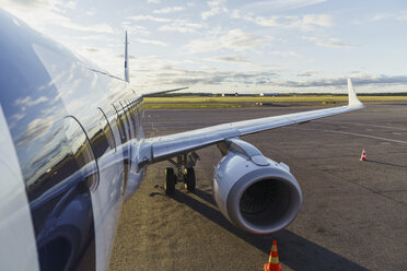 Wing of a plane standing in runway - KKAF01792