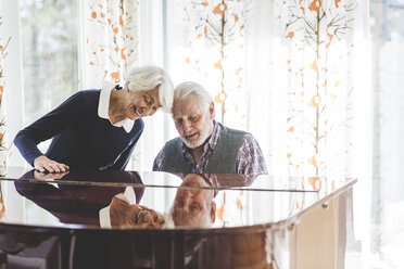 Senior couple playing piano together in nursing home - MASF08938