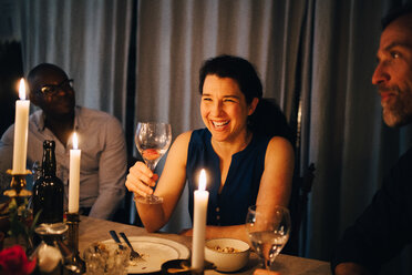 Happy woman enjoying dinner party with friends at home - MASF09033