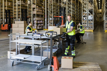 Multi-ethnic coworkers working at distribution warehouse - MASF09128