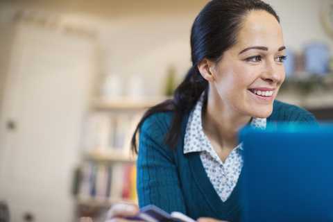 Lächelnde Frau mit Laptop, lizenzfreies Stockfoto