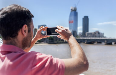 UK, London, tourist taking a cell phone picture on the Millennium Bridge - MGOF03782