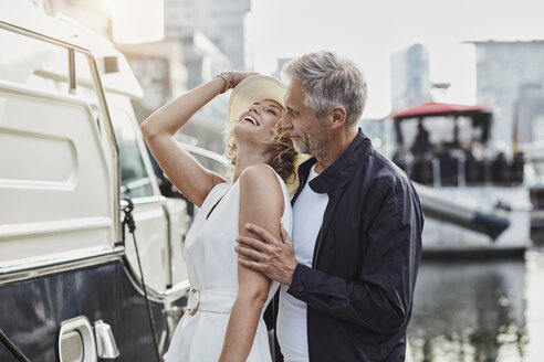 Older man and young woman at a marina next to a yacht - RORF01561
