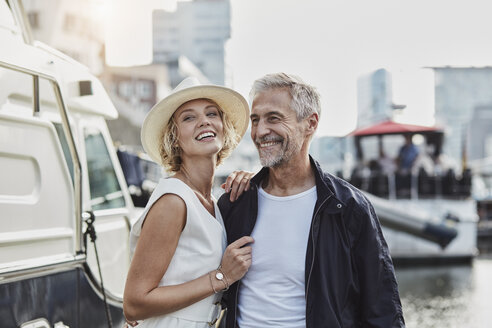 Older man and young woman at a marina next to a yacht - RORF01563