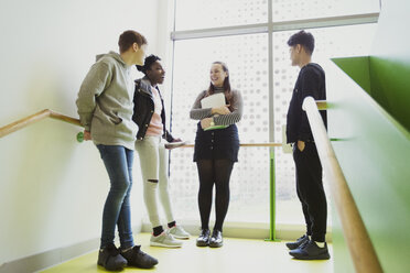 High school students talking on stair landing - CAIF21840