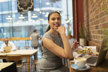 Selbstbewusste Geschäftsfrau beim Mittagessen und bei der Arbeit im Cafe - CAIF21950